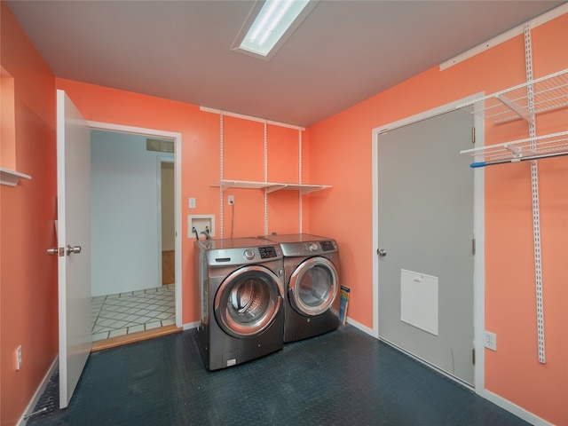 clothes washing area with separate washer and dryer