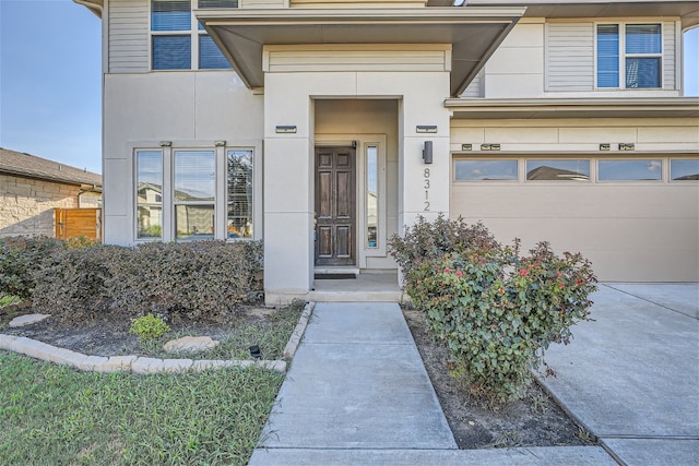 doorway to property with a garage