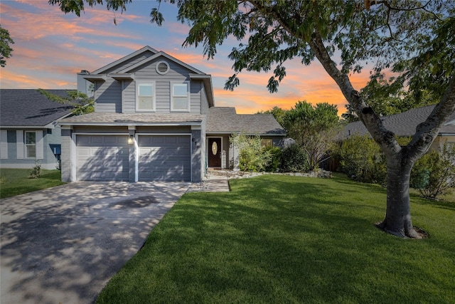 view of front of property with a garage and a lawn