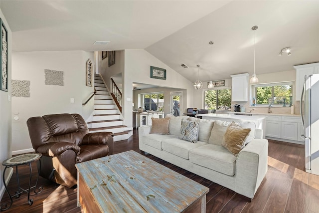 living room featuring dark wood-type flooring and high vaulted ceiling