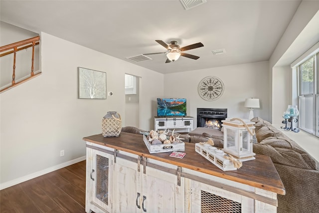 living room with dark wood-type flooring and ceiling fan