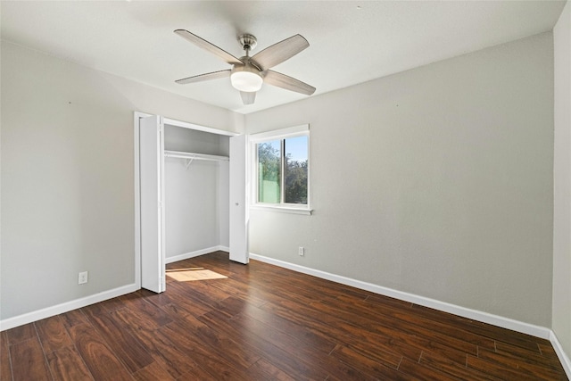 unfurnished bedroom featuring dark hardwood / wood-style floors, a closet, and ceiling fan