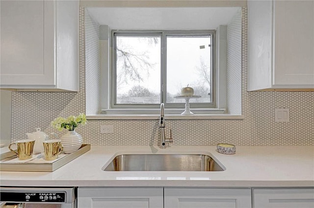 kitchen with white cabinetry, tasteful backsplash, sink, and dishwasher