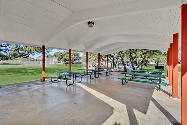 view of property's community featuring a yard and a patio