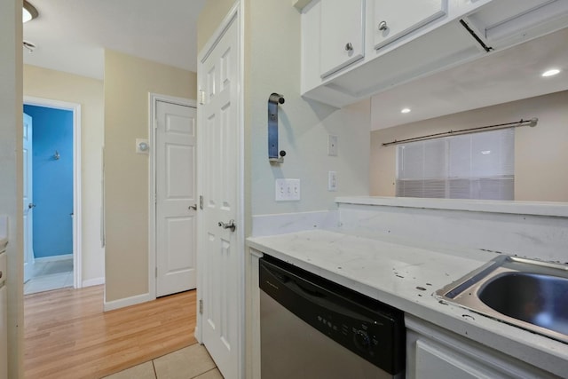 kitchen with sink, light hardwood / wood-style floors, dishwasher, and white cabinets