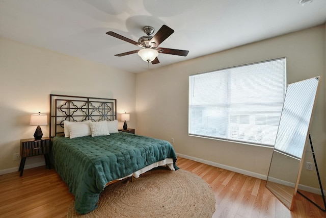 bedroom with light hardwood / wood-style floors and ceiling fan