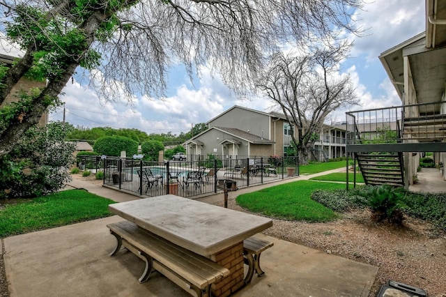 surrounding community featuring a patio and a lawn