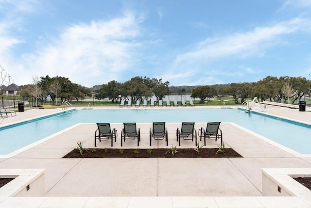 community pool featuring a patio and fence