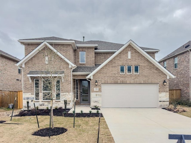 traditional-style house with brick siding, a shingled roof, a garage, stone siding, and driveway