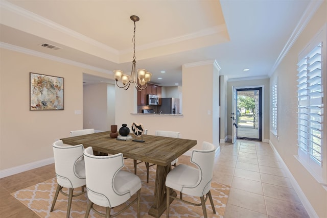 tiled dining room with a raised ceiling, crown molding, and a notable chandelier