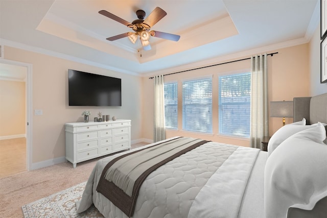 carpeted bedroom featuring a raised ceiling, ceiling fan, and ornamental molding