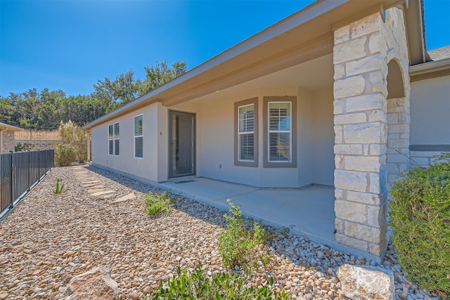 doorway to property with a patio