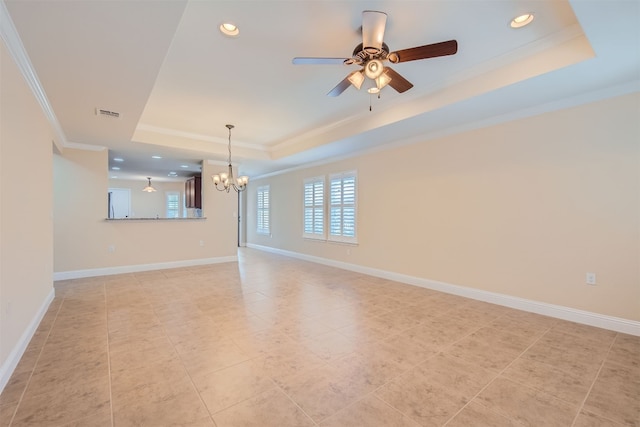 unfurnished living room with ceiling fan with notable chandelier, a raised ceiling, ornamental molding, and light tile patterned floors