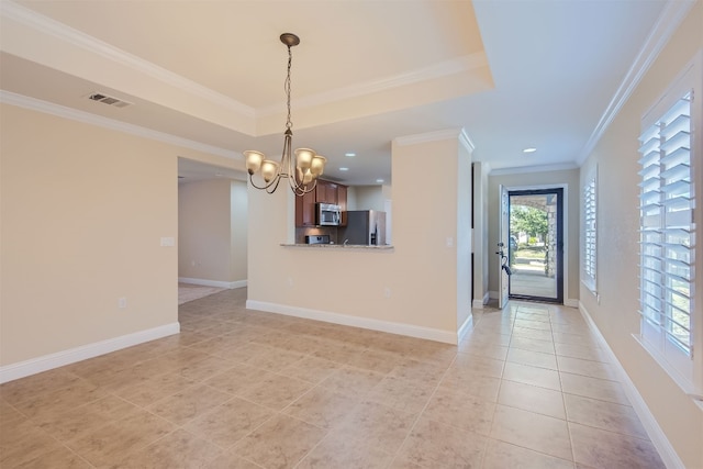 interior space with an inviting chandelier, ornamental molding, appliances with stainless steel finishes, light tile patterned flooring, and kitchen peninsula