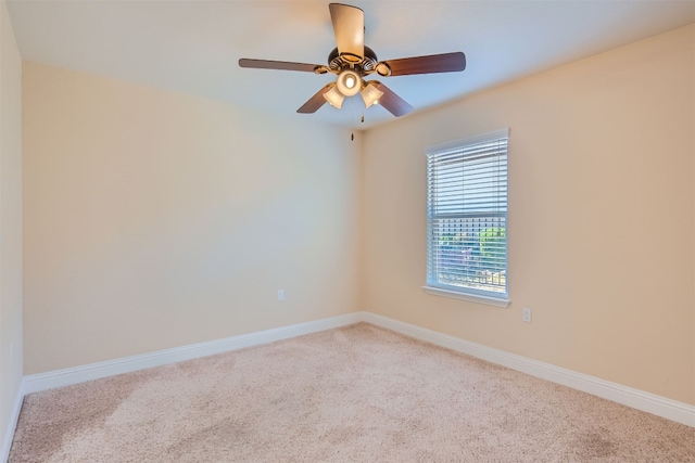 spare room featuring carpet floors and ceiling fan