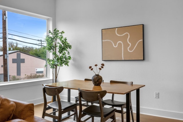 dining space with a healthy amount of sunlight and hardwood / wood-style floors