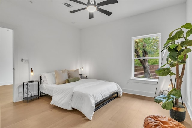 bedroom with light hardwood / wood-style flooring and ceiling fan