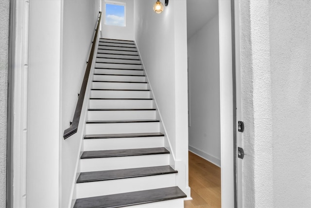 staircase featuring wood-type flooring