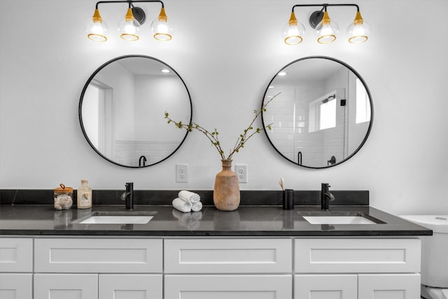 bathroom featuring vanity, toilet, and a shower