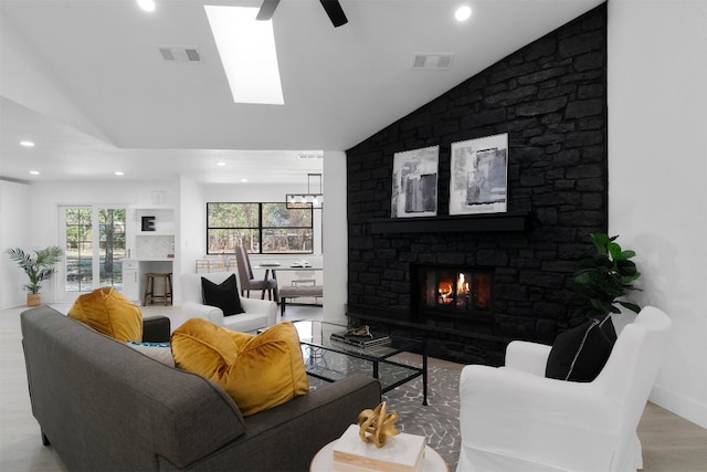 living room with light hardwood / wood-style floors, lofted ceiling, a fireplace, and ceiling fan