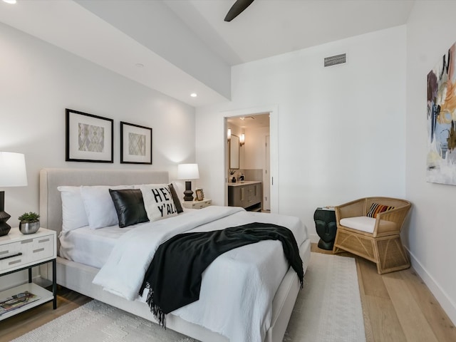 bedroom with connected bathroom, light hardwood / wood-style floors, and ceiling fan