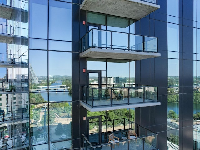 doorway to property featuring a water view and a balcony