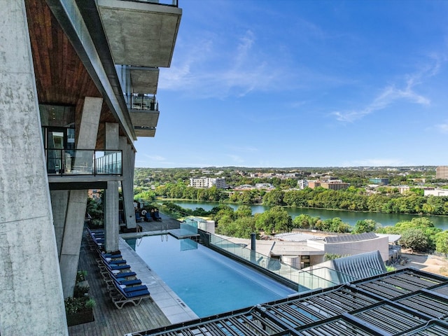 view of pool featuring a water view