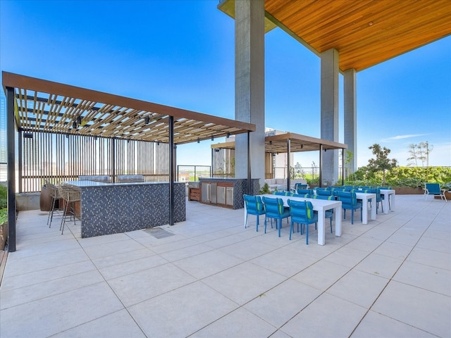 view of patio with a pergola and exterior bar