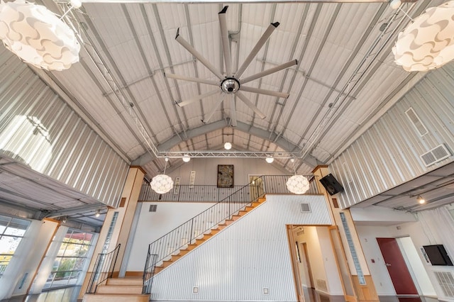 staircase featuring high vaulted ceiling