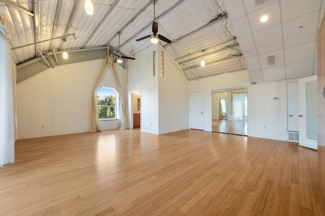 interior space featuring light wood-type flooring, high vaulted ceiling, and ceiling fan