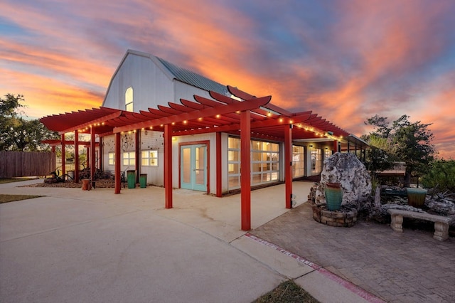 TBD Hibbs Lane, Manor, TX 78653 - patio terrace at dusk featuring a pergola, fence, and french doors