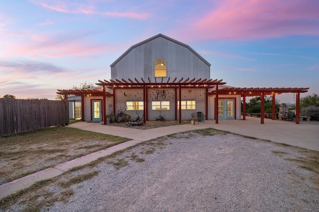 view of front of house with french doors, fence, a patio, and a pergola