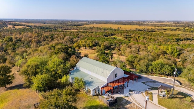 drone / aerial view featuring a wooded view