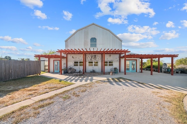 view of outbuilding featuring a pergola and french doors