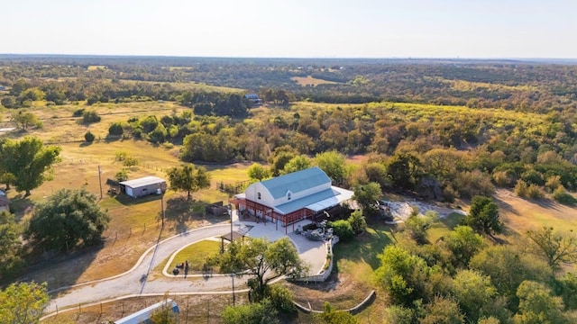 bird's eye view with a wooded view