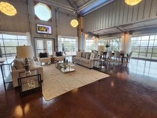 living room featuring french doors and a towering ceiling