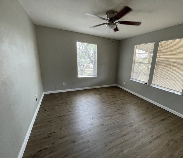 empty room with ceiling fan and dark hardwood / wood-style floors