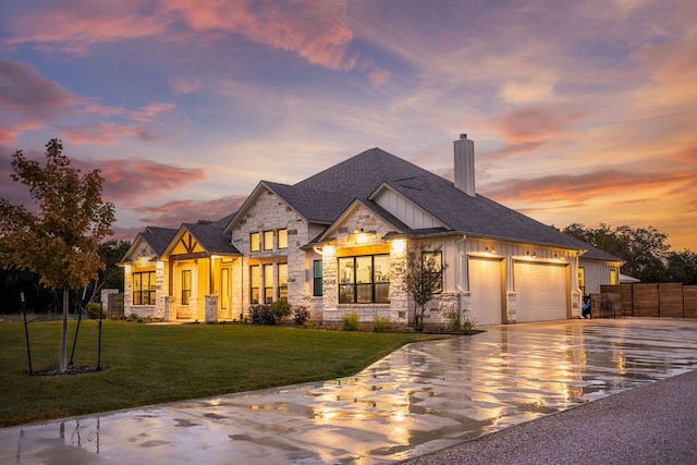 french provincial home with fence, stone siding, a garage, board and batten siding, and a chimney