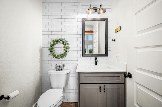 half bath featuring toilet and vanity