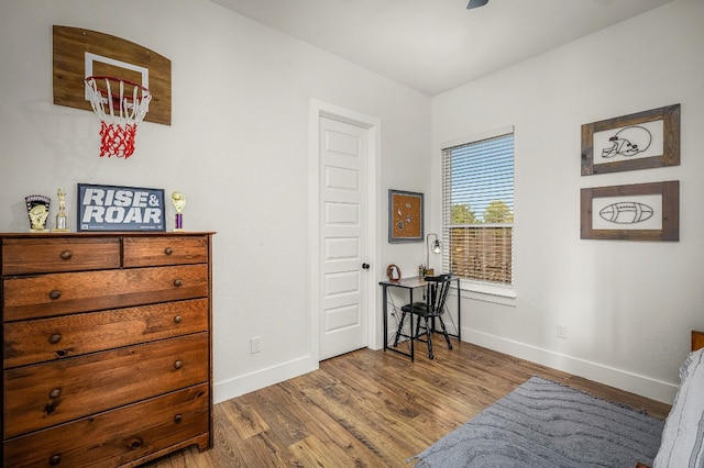 living area featuring baseboards and wood finished floors
