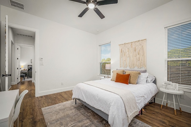 bedroom with dark hardwood / wood-style flooring and ceiling fan