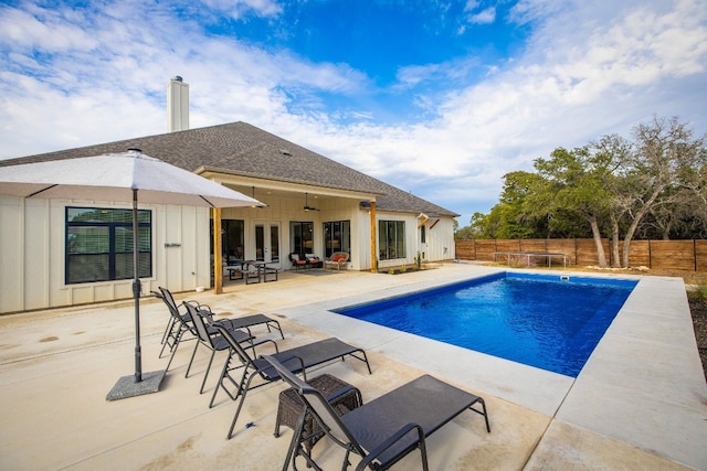 view of pool featuring ceiling fan, french doors, a fenced in pool, a fenced backyard, and a patio