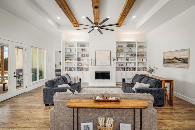 living room with ceiling fan, a fireplace, beam ceiling, wood finished floors, and recessed lighting