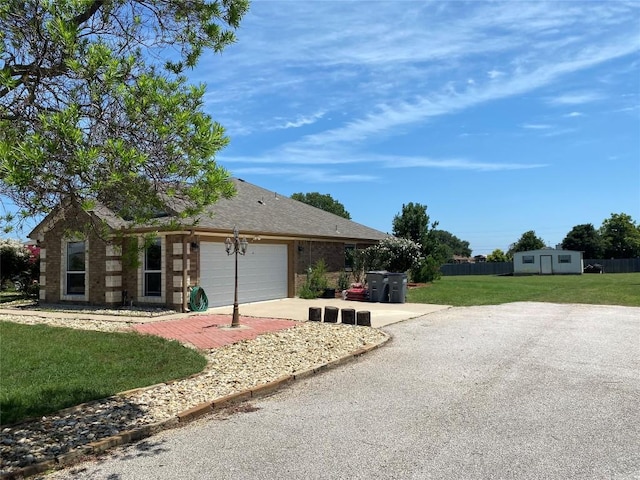 ranch-style home with a garage and a front yard