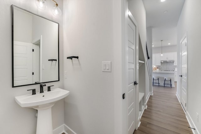 bathroom featuring tasteful backsplash and wood-type flooring