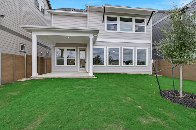 back of house featuring a yard and a patio