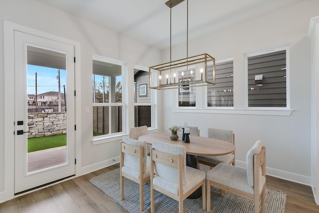 dining room featuring hardwood / wood-style floors and a chandelier