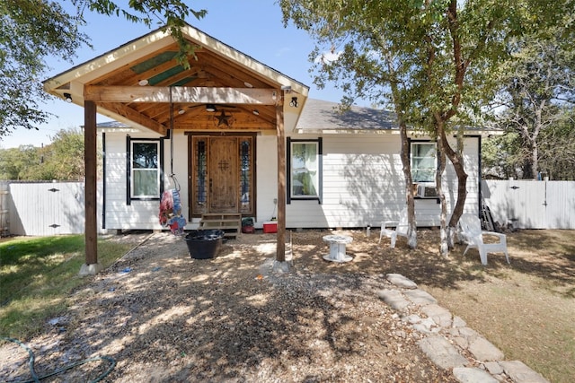 bungalow-style house with cooling unit and ceiling fan