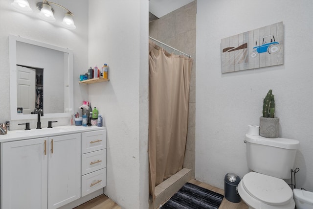 bathroom featuring vanity, hardwood / wood-style floors, toilet, and walk in shower