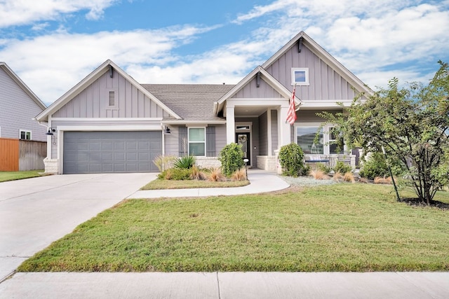 craftsman-style home with covered porch, a garage, and a front lawn